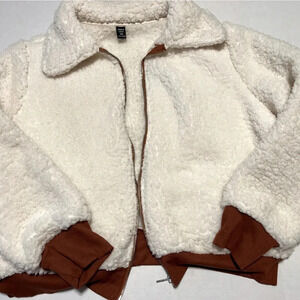 Women zip up white and brown teddy, cozy long sleeve for casual comfort.